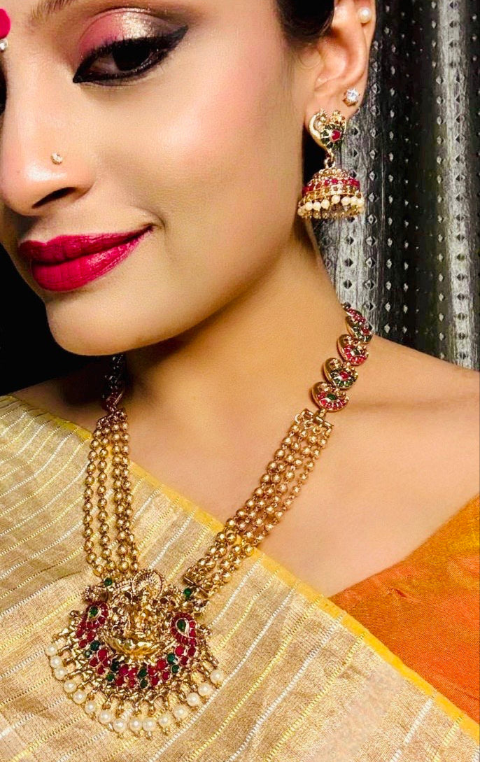 Janaki Long Haram Necklace with Mayura motif Jhumkis